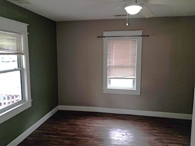 2412 W Olive St, Springfield, MO 65802 - empty room featuring dark wood-style flooring and a ceiling fan
