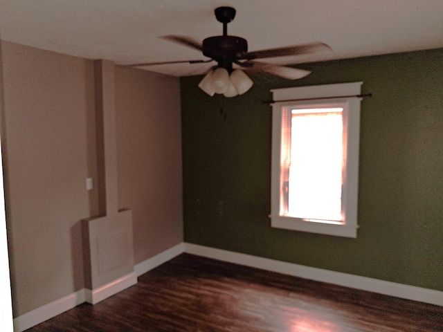 2412 W Olive St, Springfield, MO 65802 - spare room featuring plenty of natural light, a ceiling fan, and dark wood-style flooring