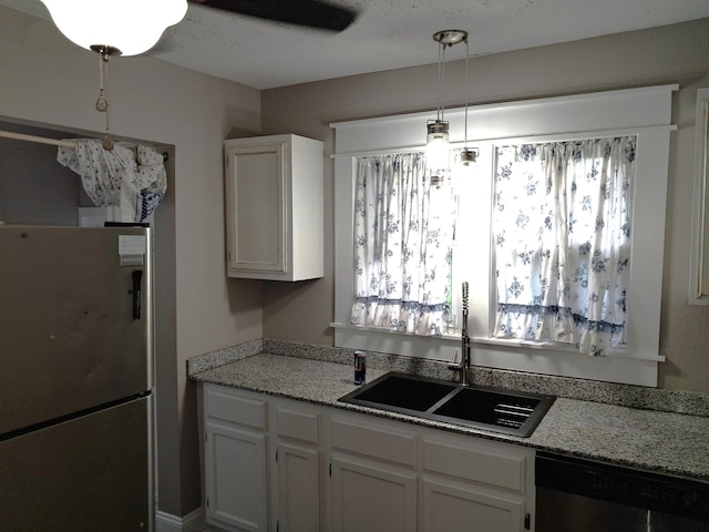 2412 W Olive St, Springfield, MO 65802 - kitchen with appliances with stainless steel finishes, white cabinets, and light stone counters