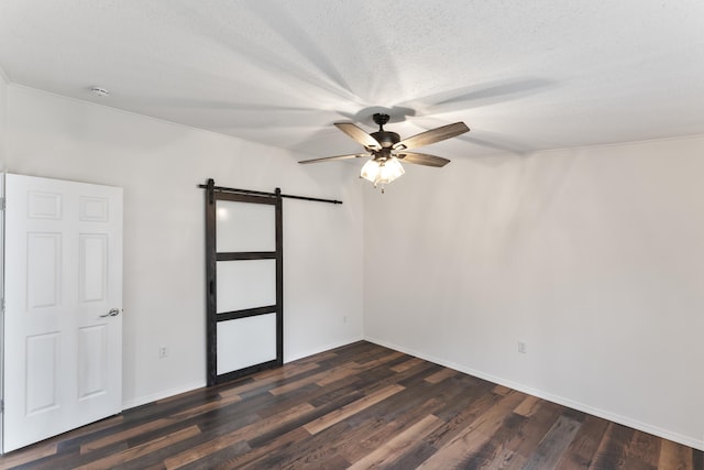 150 Woodward Dr, Branson, MO 65616 - unfurnished bedroom featuring a barn door, dark wood-style floors, a ceiling fan, and a textured ceiling
