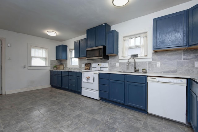 1612 N Grant Ave, Springfield, MO 65803 - kitchen with white appliances, blue cabinetry, backsplash, light countertops, and dark stone finish floors