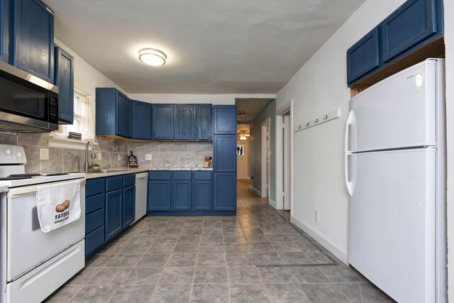 1612 N Grant Ave, Springfield, MO 65803 - kitchen with white appliances, blue cabinetry, backsplash, and light countertops