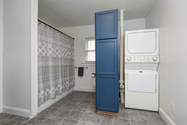 1612 N Grant Ave, Springfield, MO 65803 - washroom featuring estacked washer and dryer and tile patterned floors