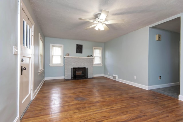 1612 N Grant Ave, Springfield, MO 65803 - unfurnished living room with wood finished floors, ceiling fan, and a textured ceiling