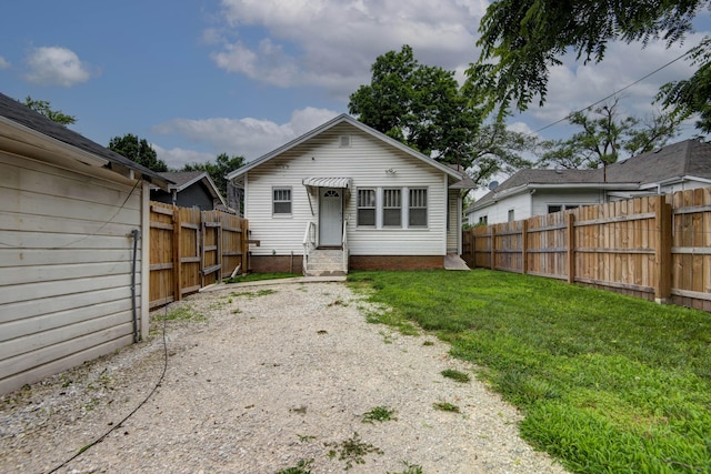 1612 N Grant Ave, Springfield, MO 65803 - rear view of house featuring a fenced backyard and entry steps