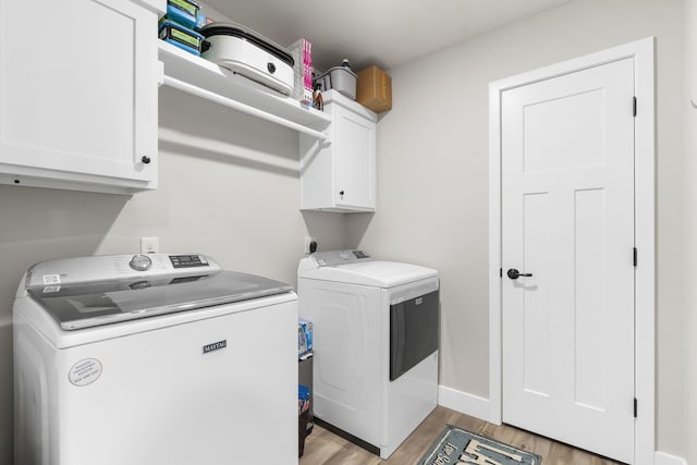 427 N Maynard Rd, Nixa, MO 65714 - washroom featuring independent washer and dryer, cabinet space, and light wood-style flooring