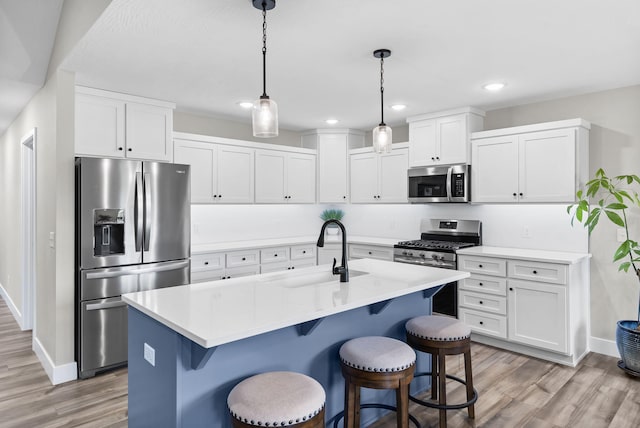 427 N Maynard Rd, Nixa, MO 65714 - kitchen featuring appliances with stainless steel finishes, a breakfast bar area, light wood-type flooring, and recessed lighting