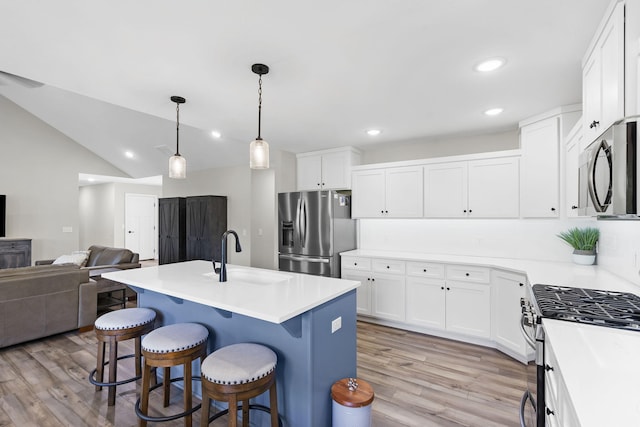 427 N Maynard Rd, Nixa, MO 65714 - kitchen with stainless steel appliances, light wood-type flooring, open floor plan, white cabinetry, and recessed lighting