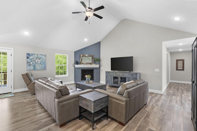 427 N Maynard Rd, Nixa, MO 65714 - living room with a ceiling fan, light wood finished floors, lofted ceiling, a warm lit fireplace, and recessed lighting
