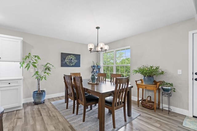 427 N Maynard Rd, Nixa, MO 65714 - dining area with light wood finished floors and a chandelier