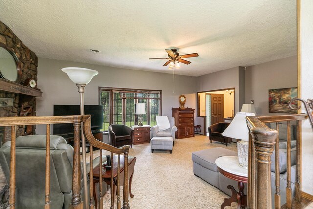 2620 Big Timber Rd, Marshfield, MO 65706 - carpeted living area featuring a textured ceiling, ceiling fan, and a fireplace
