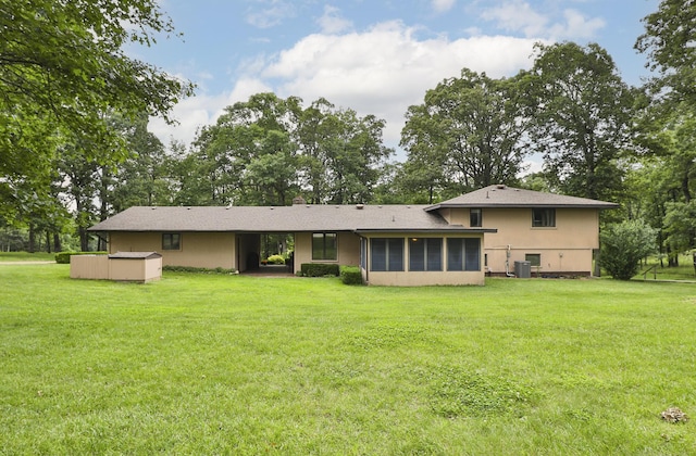 2620 Big Timber Rd, Marshfield, MO 65706 - back of property featuring a sunroom, a lawn, and stucco siding