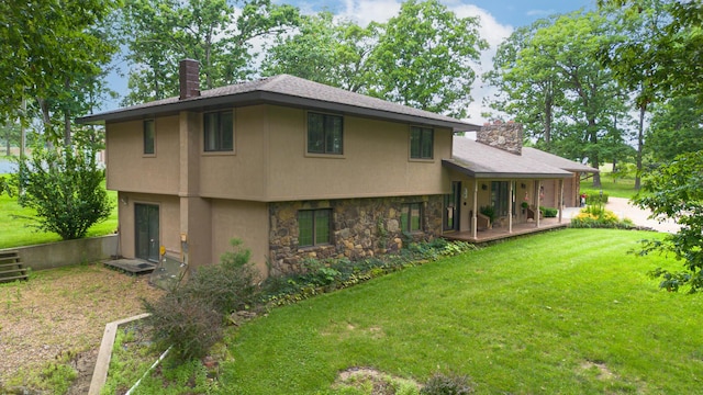 2620 Big Timber Rd, Marshfield, MO 65706 - rear view of house featuring a chimney, stone siding, a yard, and a porch