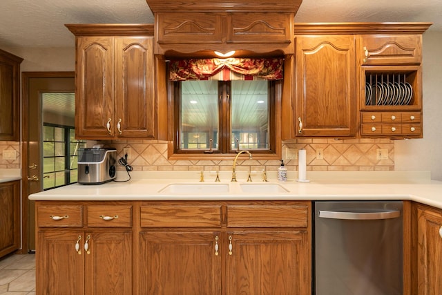 2620 Big Timber Rd, Marshfield, MO 65706 - kitchen with dishwasher, backsplash, light countertops, and brown cabinetry