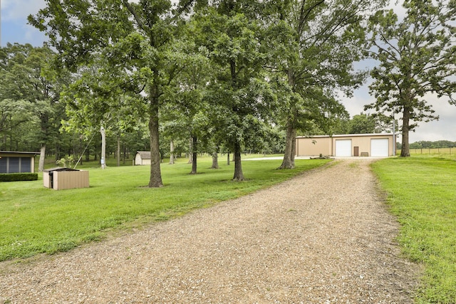 2620 Big Timber Rd, Marshfield, MO 65706 - view of front of house with a front yard, a storage unit, dirt driveway, and a detached garage