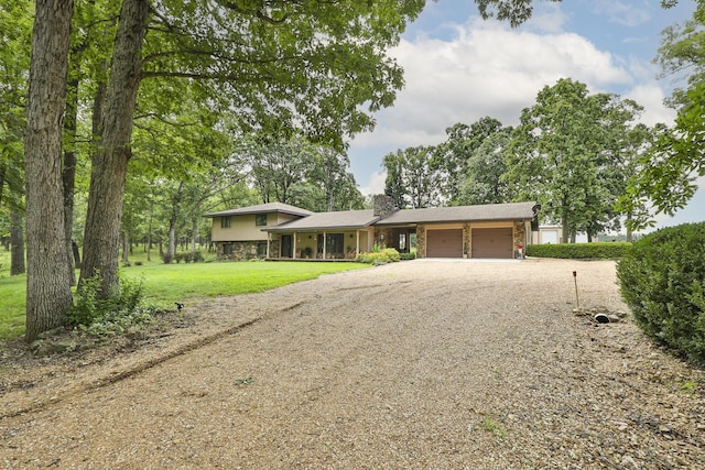 2620 Big Timber Rd, Marshfield, MO 65706 - tri-level home featuring a chimney, an attached garage, gravel driveway, a front lawn, and stone siding