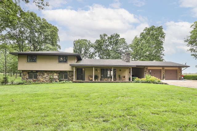 2620 Big Timber Rd, Marshfield, MO 65706 - tri-level home with stone siding, a garage, driveway, and a front lawn