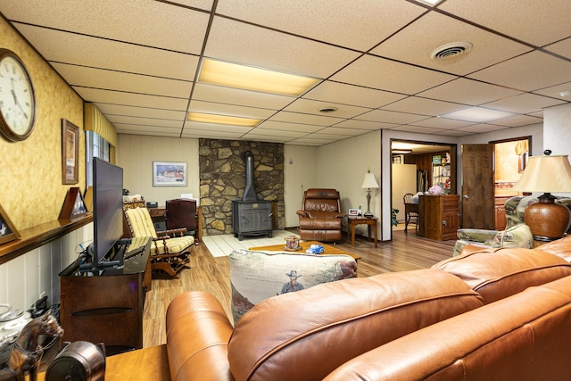 2620 Big Timber Rd, Marshfield, MO 65706 - living area with a wood stove, wood finished floors, and a paneled ceiling