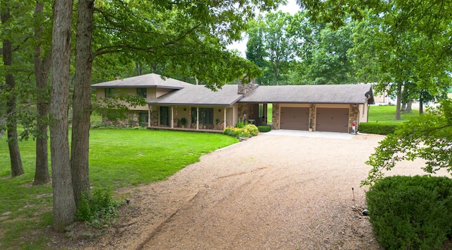 2620 Big Timber Rd, Marshfield, MO 65706 - view of front of property with stone siding, an attached garage, driveway, a front yard, and a porch