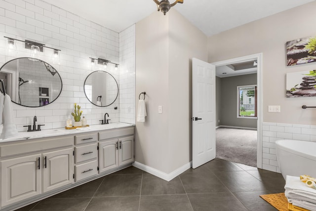 903 E Elizabeth St, Republic, MO 65738 - bathroom featuring tile walls, tile patterned flooring, double vanity, and a freestanding tub