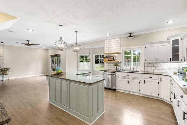 903 E Elizabeth St, Republic, MO 65738 - kitchen with stainless steel dishwasher, a ceiling fan, backsplash, white cabinets, and crown molding