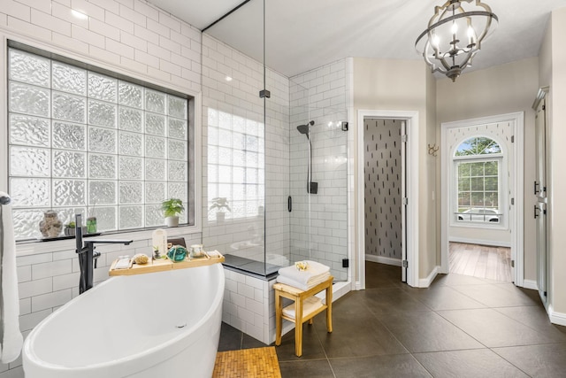 903 E Elizabeth St, Republic, MO 65738 - bathroom featuring a shower stall, a soaking tub, tile patterned floors, and a chandelier