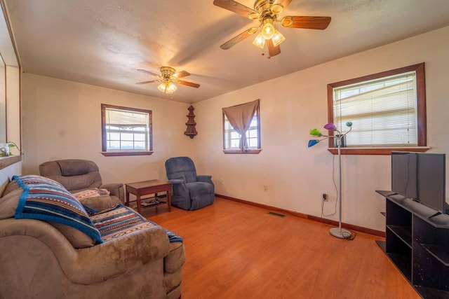 15608 Lawrence Unit 2007, Miller, MO 65707 - living area with ceiling fan, wood finished floors, and plenty of natural light