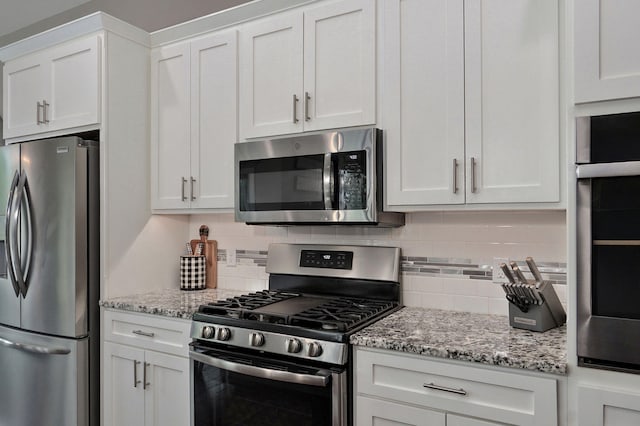 926 E Downshire Dr, Nixa, MO 65714 - kitchen with appliances with stainless steel finishes, decorative backsplash, and white cabinets