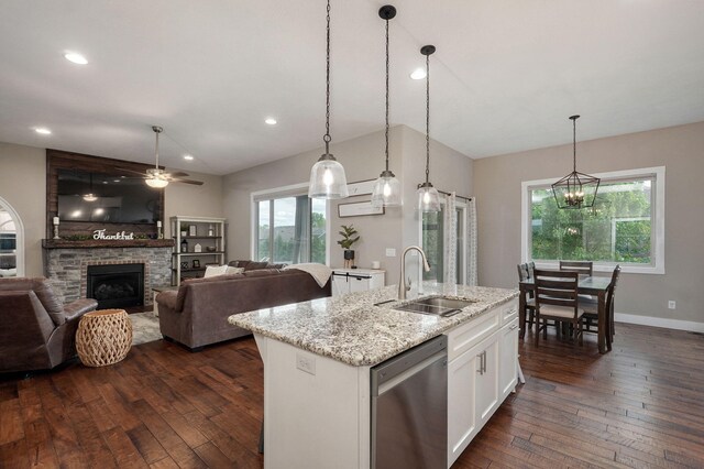 926 E Downshire Dr, Nixa, MO 65714 - kitchen with dishwasher, ceiling fan, white cabinets, dark wood-type flooring, and a large fireplace