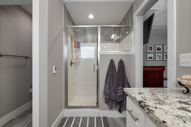926 E Downshire Dr, Nixa, MO 65714 - bathroom with vanity, a shower stall, and wood finished floors