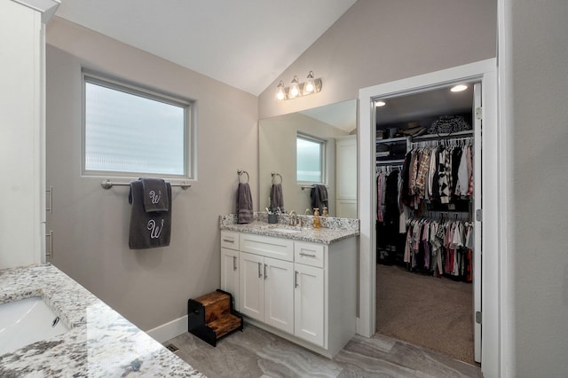 926 E Downshire Dr, Nixa, MO 65714 - bathroom featuring vanity, lofted ceiling, and a spacious closet