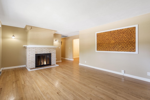 1722 S Link Ave, Springfield, MO 65804 - unfurnished living room with light wood-type flooring and a brick fireplace