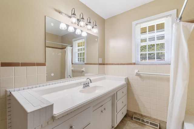 1722 S Link Ave, Springfield, MO 65804 - full bathroom with tile walls, vanity, a shower with curtain, wainscoting, and tile patterned flooring