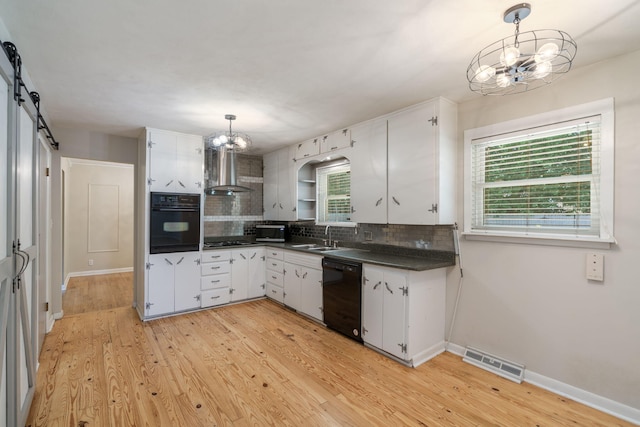 1722 S Link Ave, Springfield, MO 65804 - kitchen with black appliances, a chandelier, wall chimney range hood, dark countertops, and backsplash