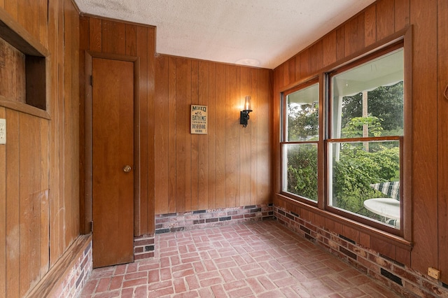 610 W Summit St, Bolivar, MO 65613 - unfurnished room with brick floors and wood walls