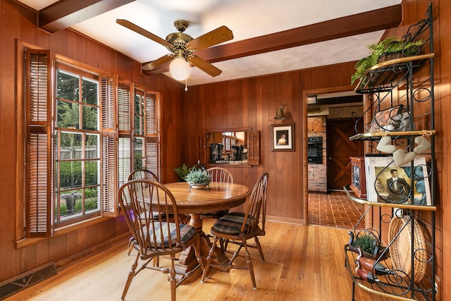 610 W Summit St, Bolivar, MO 65613 - dining space with wood walls, beam ceiling, wood finished floors, and a ceiling fan