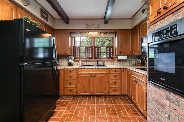 610 W Summit St, Bolivar, MO 65613 - kitchen featuring black appliances, brick patterned flooring, brown cabinetry, beamed ceiling, and tasteful backsplash