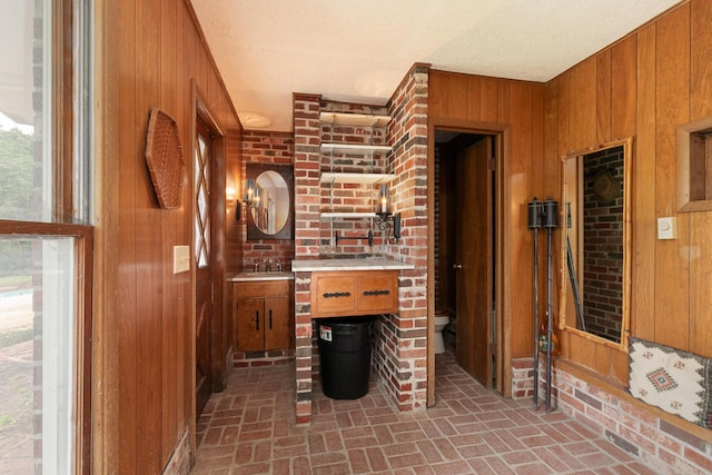 610 W Summit St, Bolivar, MO 65613 - living area with brick patterned flooring and wooden walls