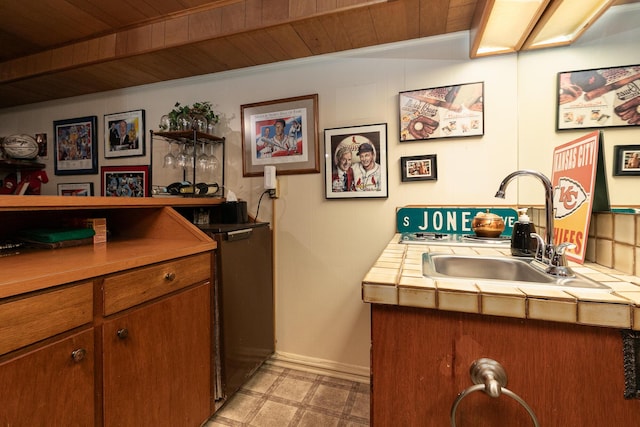 610 W Summit St, Bolivar, MO 65613 - kitchen featuring wood ceiling, brown cabinets, tile counters, and light flooring