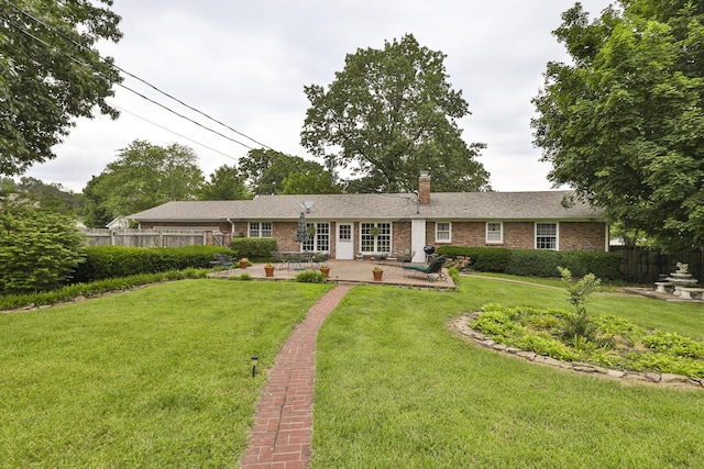 610 W Summit St, Bolivar, MO 65613 - view of front of home featuring a patio, a chimney, and brick siding