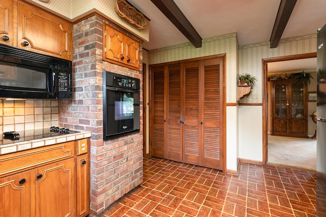 610 W Summit St, Bolivar, MO 65613 - kitchen with black appliances, wallpapered walls, tile countertops, brick patterned floors, and beamed ceiling