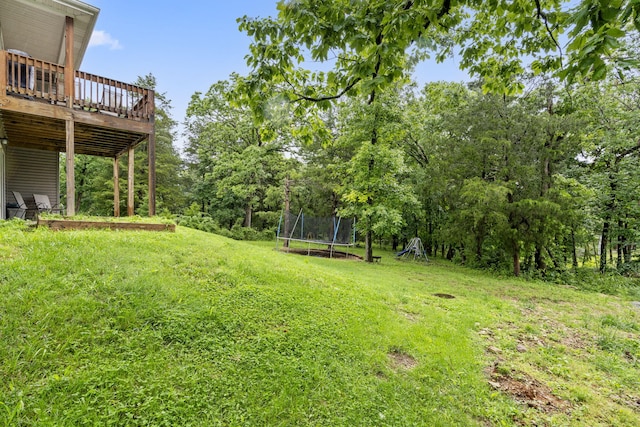 241 Everett Ml Rd, Branson, MO 65616 - view of grassy yard featuring a trampoline and a wooden deck