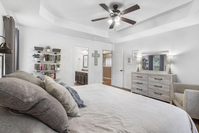 241 Everett Ml Rd, Branson, MO 65616 - bedroom featuring a raised ceiling, ensuite bathroom, and a ceiling fan