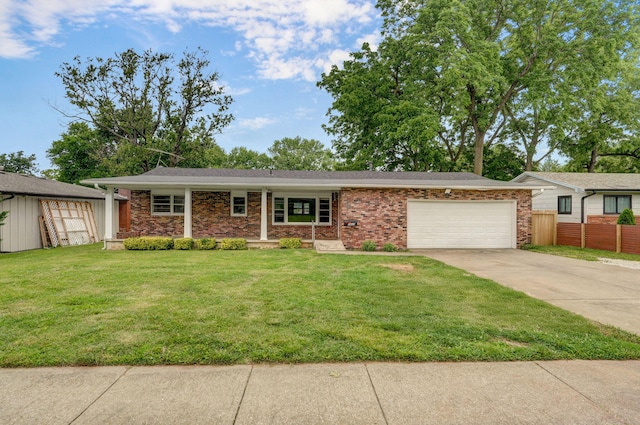 1415 S Sieger Dr, Springfield, MO 65804 - view of front of property with a garage, driveway, and brick siding