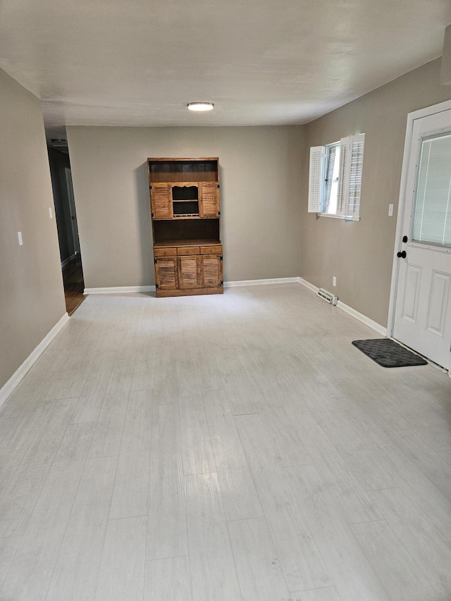 1955 S Fort Ave, Springfield, MO 65807 - unfurnished living room featuring light wood-style flooring