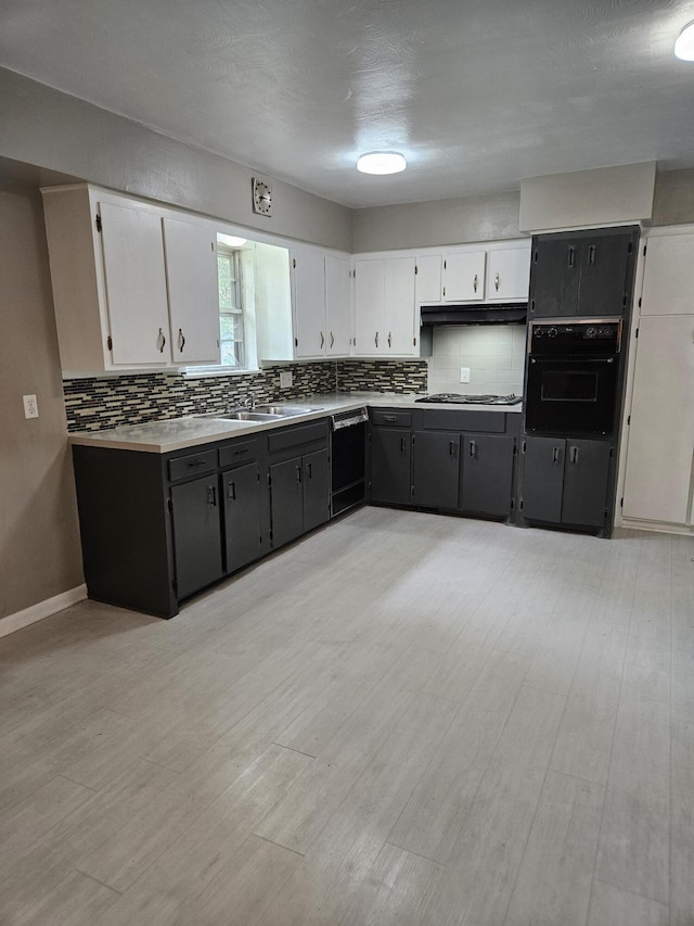1955 S Fort Ave, Springfield, MO 65807 - kitchen with black appliances, white cabinetry, tasteful backsplash, and light wood finished floors