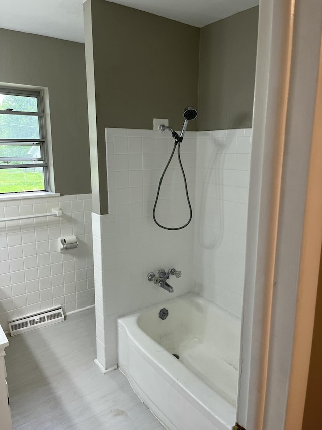 1955 S Fort Ave, Springfield, MO 65807 - full bath featuring tile walls,  shower combination, a wainscoted wall, and wood finished floors