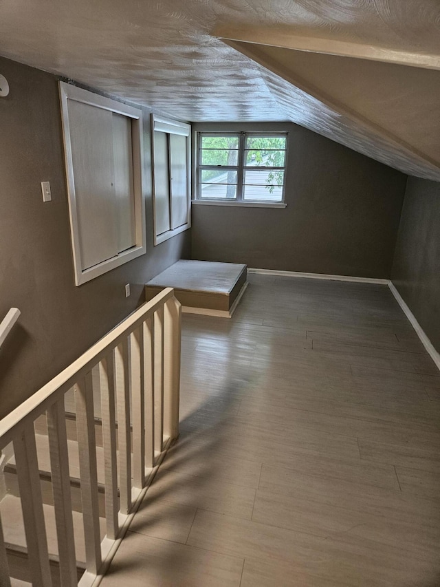 1955 S Fort Ave, Springfield, MO 65807 - additional living space featuring vaulted ceiling and wood finished floors
