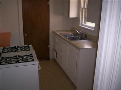 447 S New, Springfield, MO 65806 - kitchen featuring white gas range, white cabinets, and light countertops