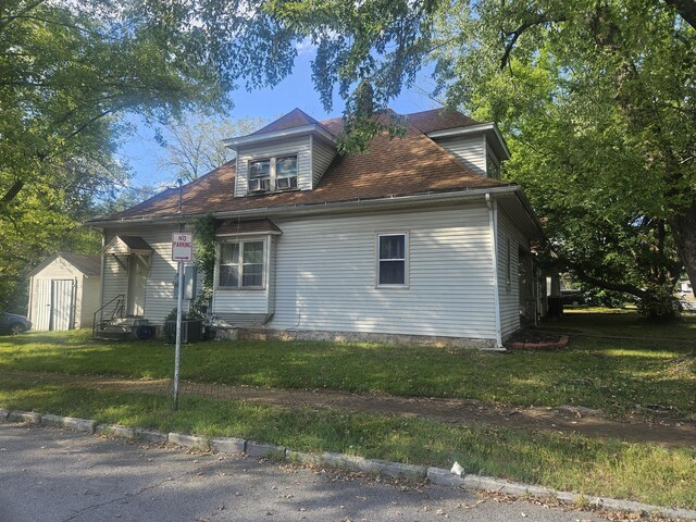 447 S New, Springfield, MO 65806 - view of home's exterior featuring a lawn, a shed, and entry steps